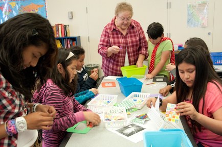 Woman helping kids with crafts