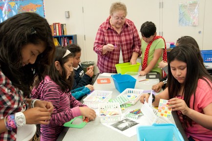 Woman helping kids with crafts